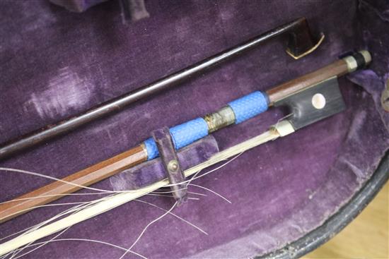 A cased violin and bows